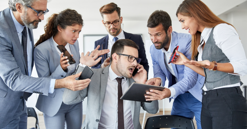 Person at desk with multiple people