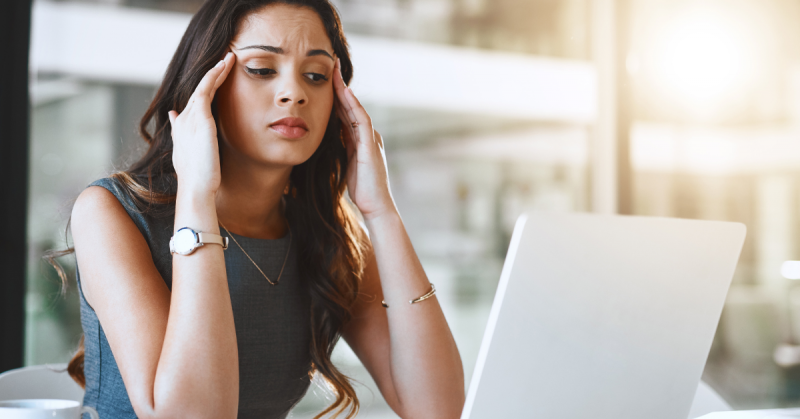 Person stressed looking at a laptop