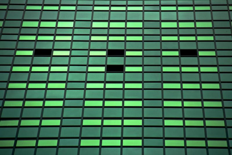 recurring payment plan metaphor with green tinted windows on large building