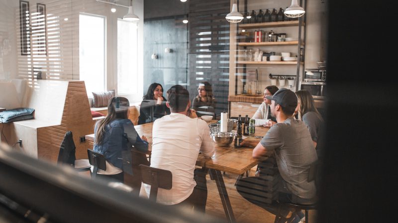 A group of young lawyers sitting around a table.