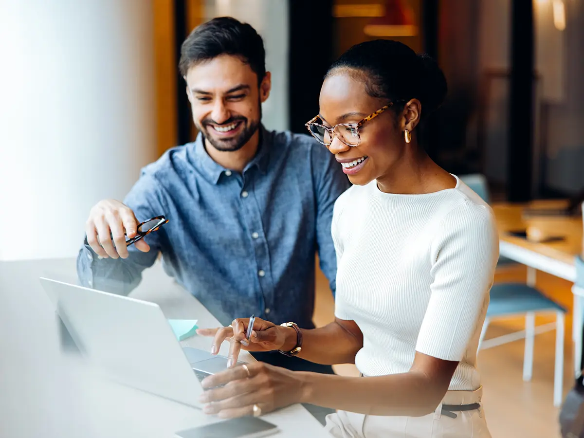 Two people looking at a computer