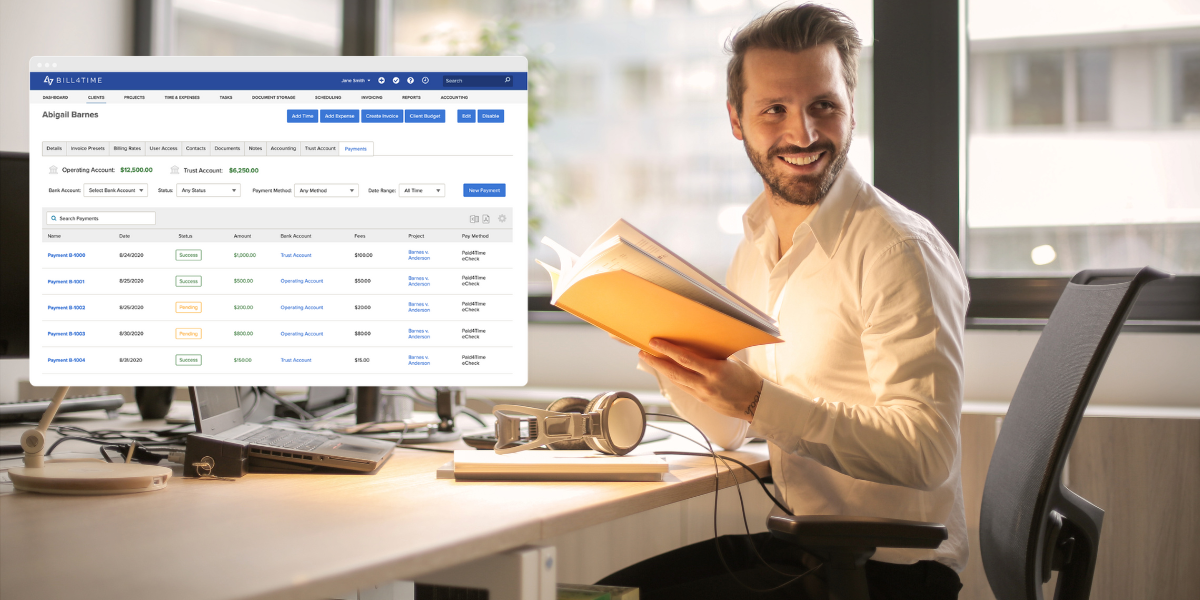 A male lawyer looking at his computer and smiling at legal billing software