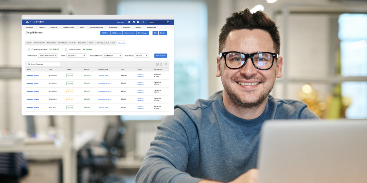 A male lawyer smiling and looking at Bill4Time on a laptop in an office